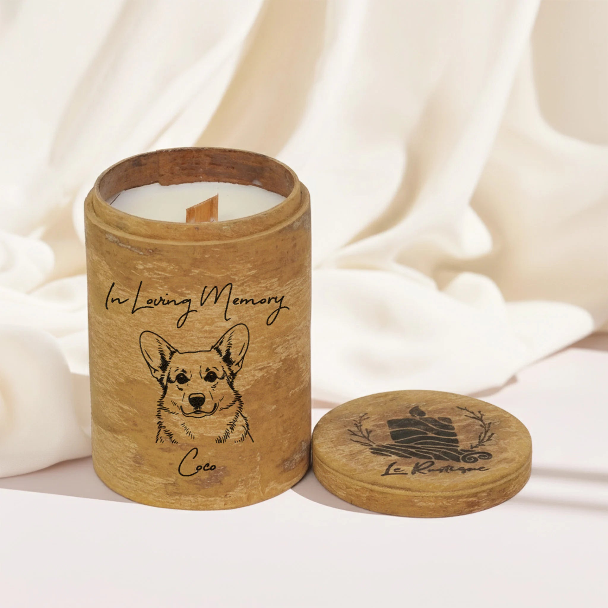 Candle in a wooden container with a dog illustration and 'In Loving Memory' text, on a soft white background.