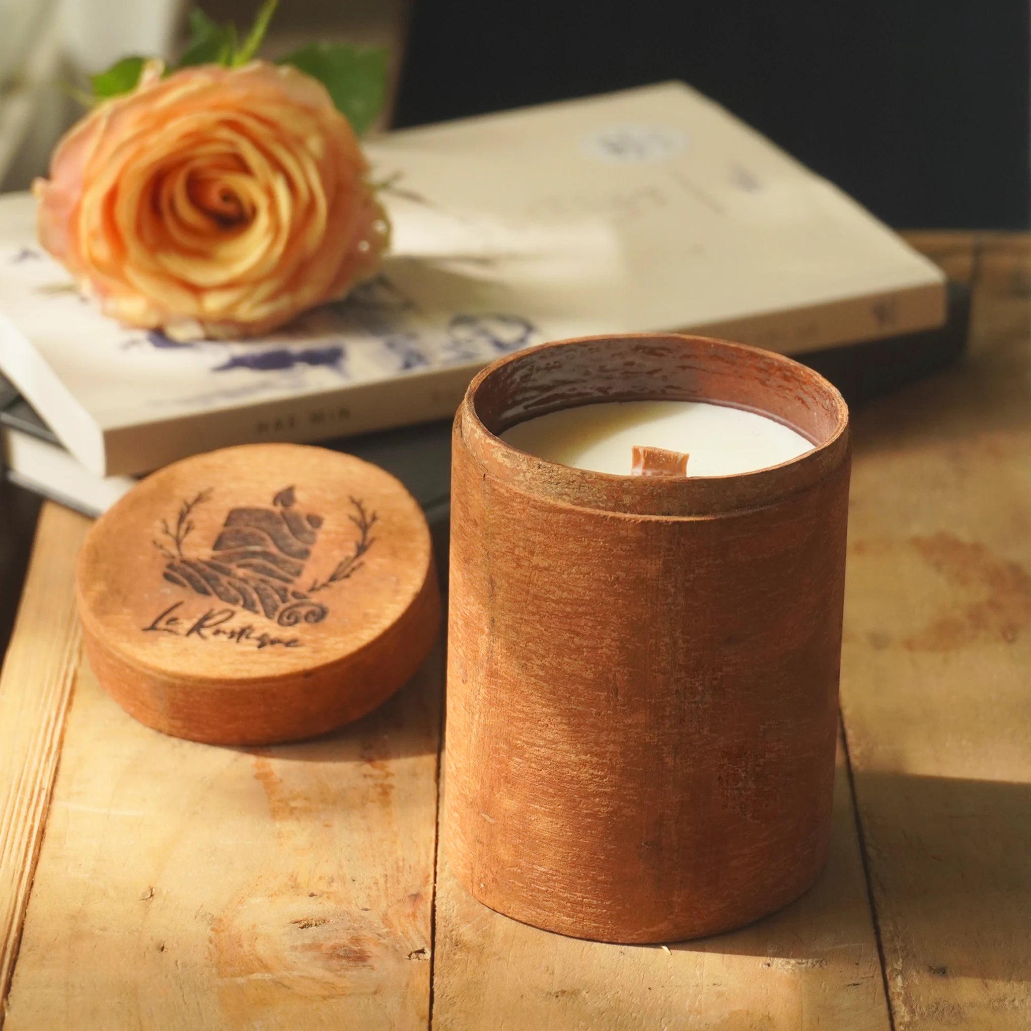 handmade scented candle in table with rose decor, romantic blend, relaxing