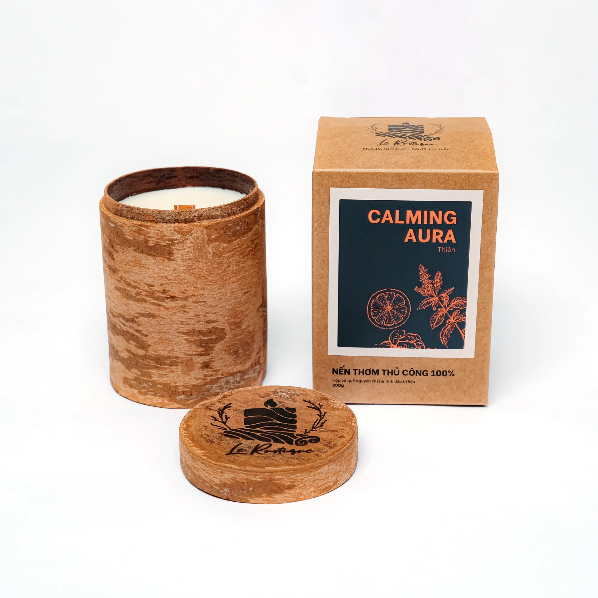 Soy Wax Candle with wooden jar holder and packaging labeled 'Calming Aura'