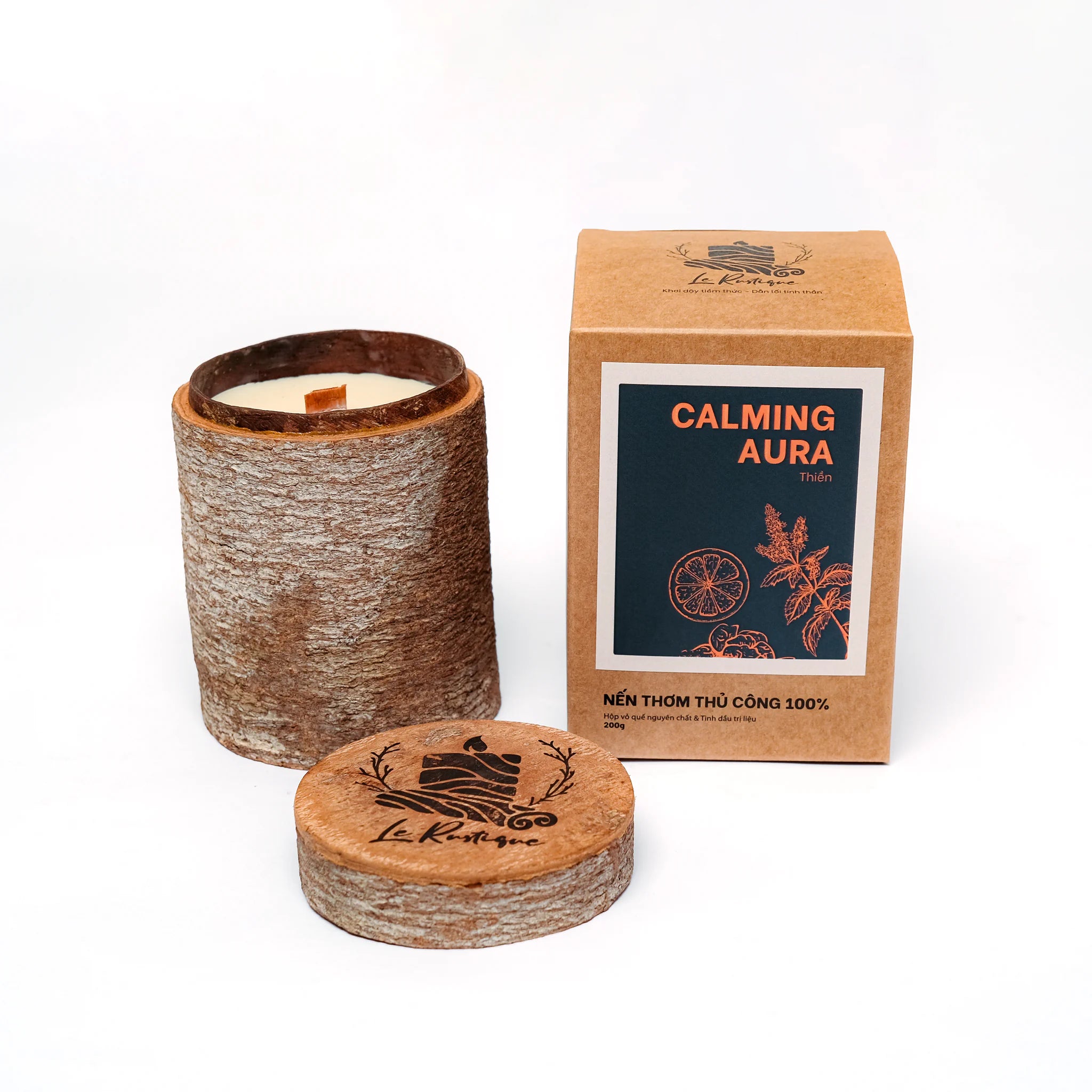 Candle with cinnamon wooden lid and coaster, and 'Calming Aura' packaging for relax