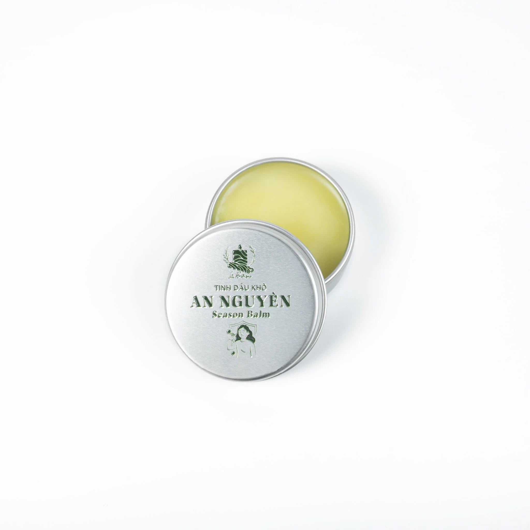 Le Rustique Season Balm in a silver tin with a green label, enriched with organic essential oil.