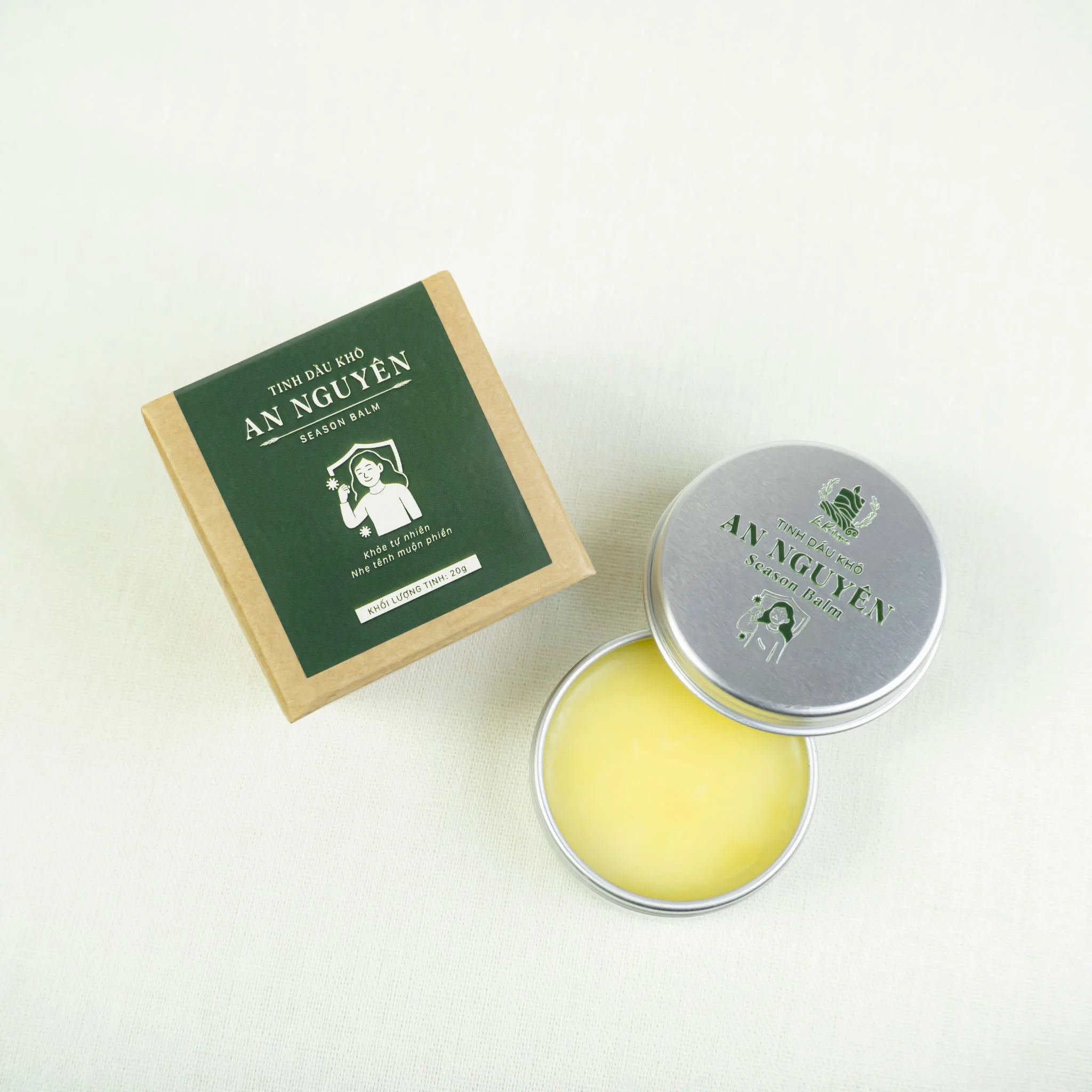 Le Rustique Season Balm in a tin with packaging featuring green design for deep moisture and aromatherapy benefits.