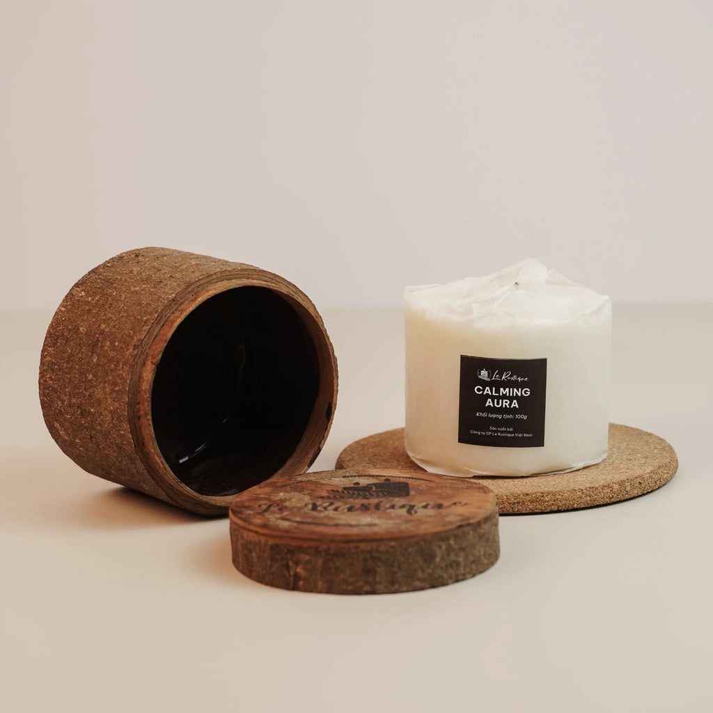 Soy wax candle refill labeled 'Calming Aura' with a cork lid and container on a light background