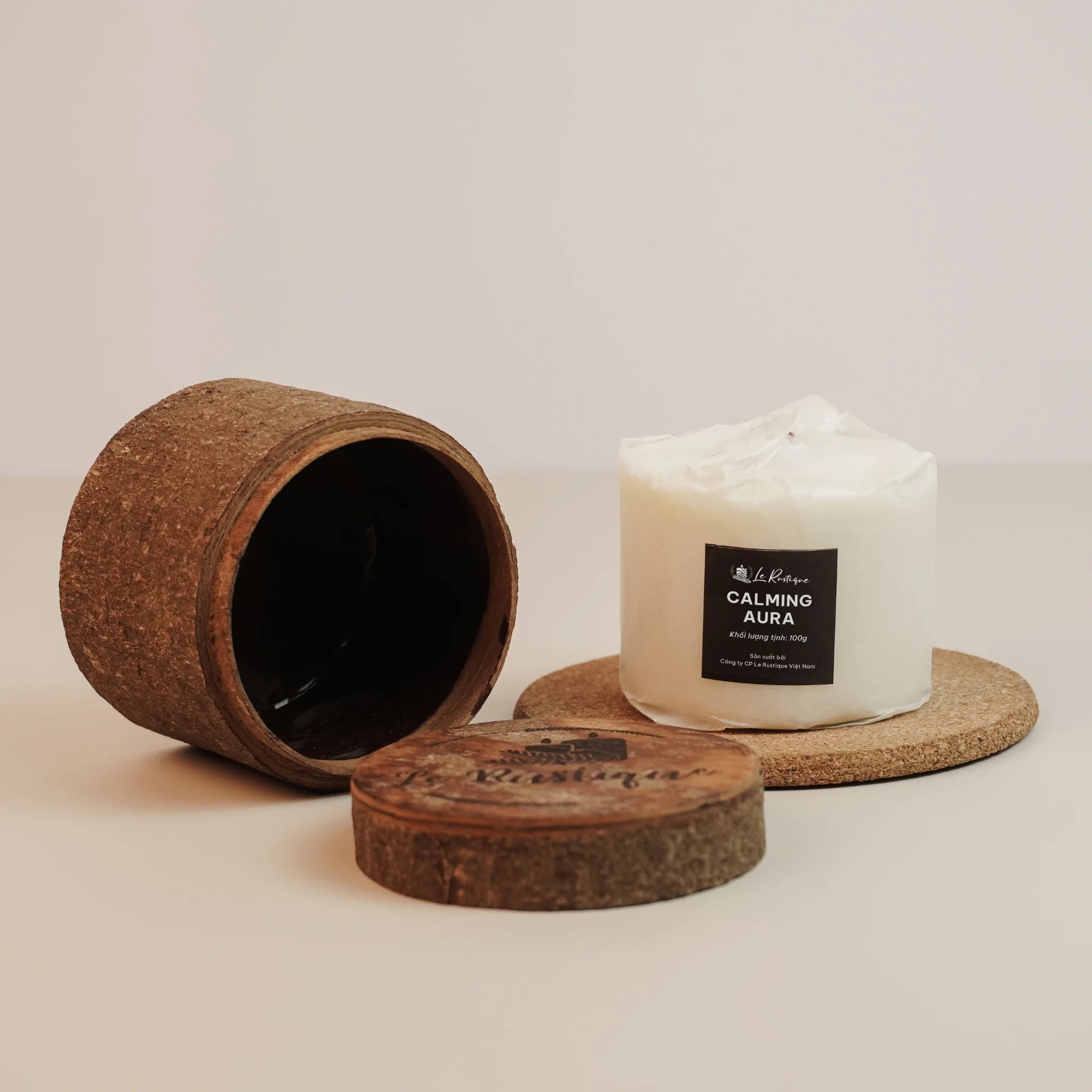 Soy wax candle refill labeled 'Calming Aura' with a cork lid and container on a light background